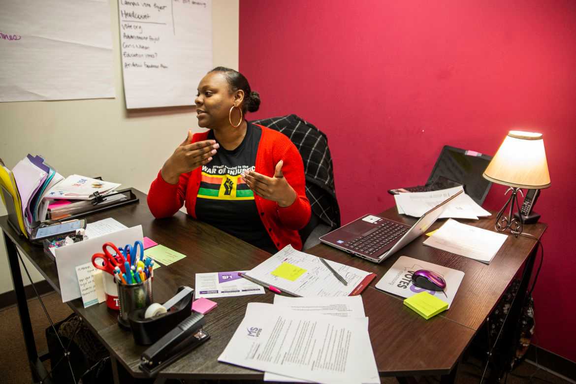 Arekia sitting at her desk.